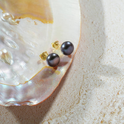 Black pearl stud earrings in gold finish