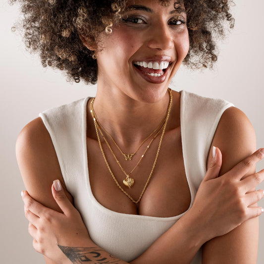 Heart leaf necklace worn by a woman