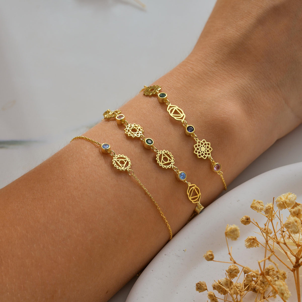 Two chakra bracelets stacked on the wrist