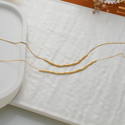 Two Morse code necklaces laid flat