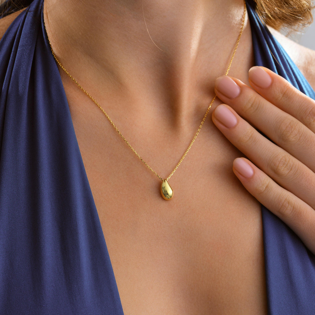 Minimalist gold drop necklace worn on the neck