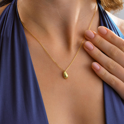 Minimalist gold drop necklace worn on the neck