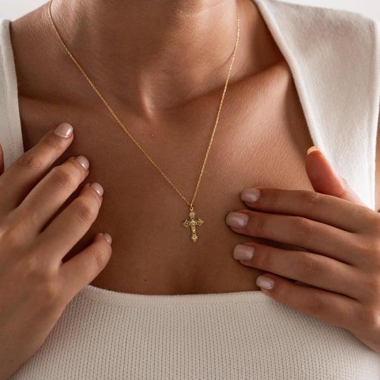 Vintage-inspired cross pendant detail