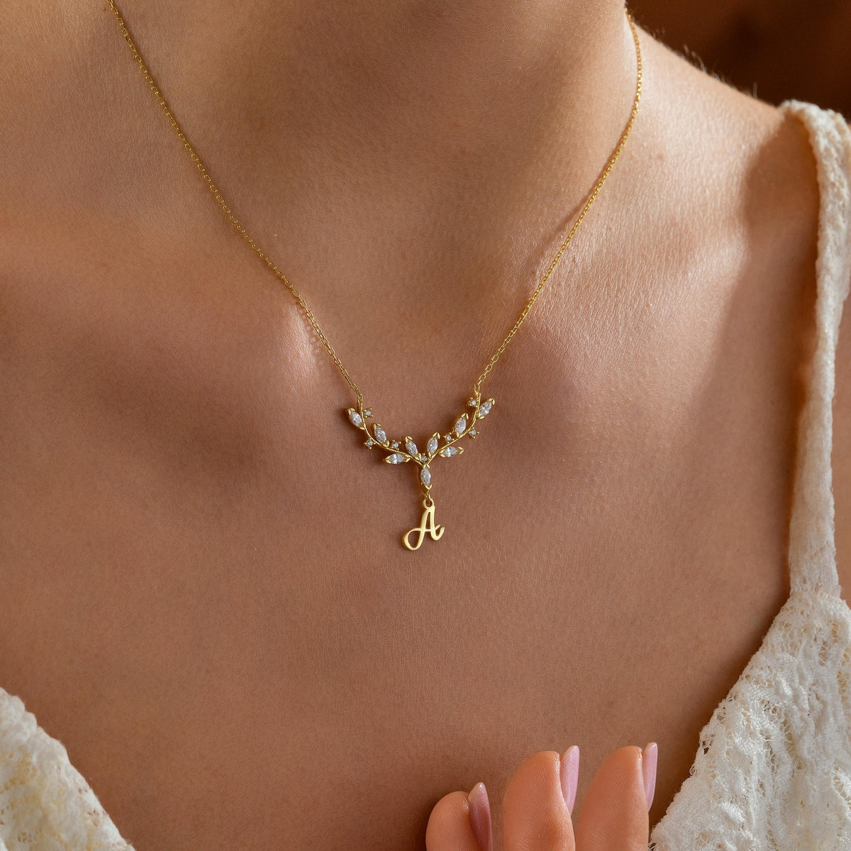Antler initial necklace worn on the neck