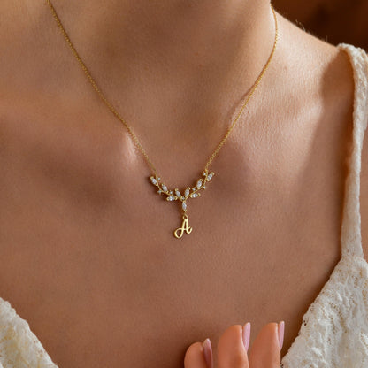 Antler initial necklace worn on the neck