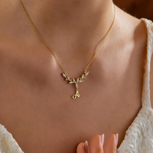 Antler initial necklace worn on the neck