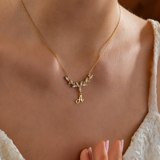 Antler initial necklace worn on the neck