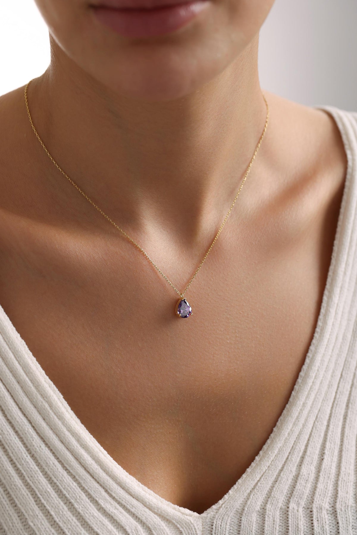 Dainty purple teardrop pendant close up