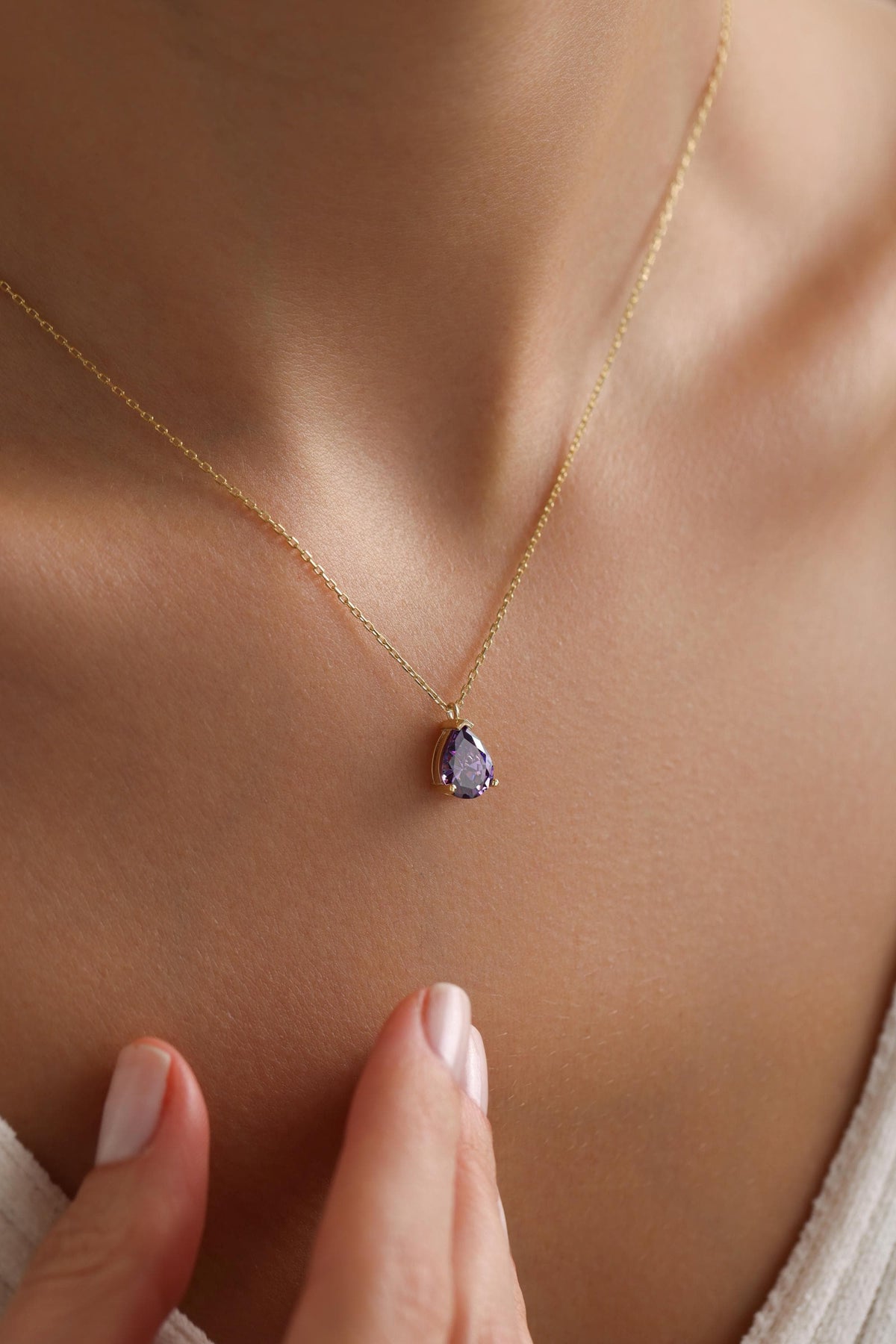 Amethyst pendant necklace shown on the collarbone
