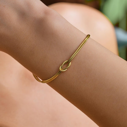 Knot bangle bracelet worn on the wrist