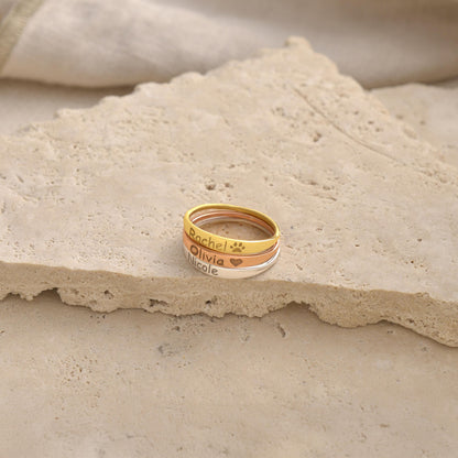 Engraved script name ring shown on a stone surface
