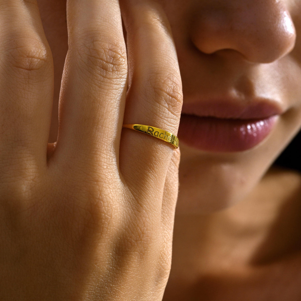 Dainty name ring worn with other rings