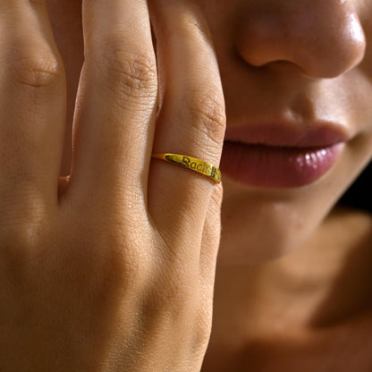 Dainty name ring worn with other rings