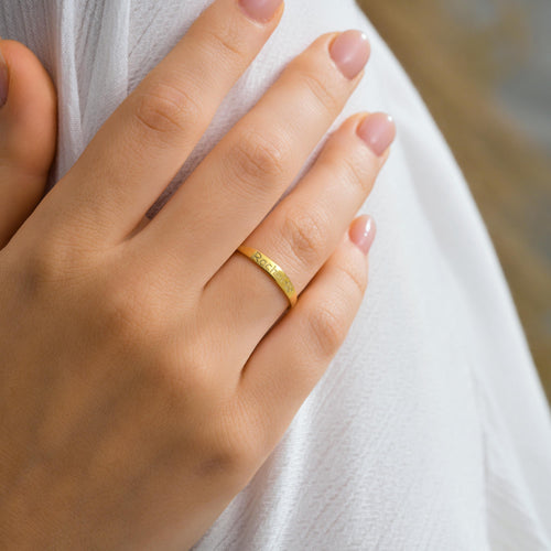 Dainty engraved name ring in gold worn on the hand