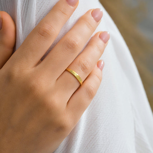 Dainty engraved name ring in gold worn on the hand