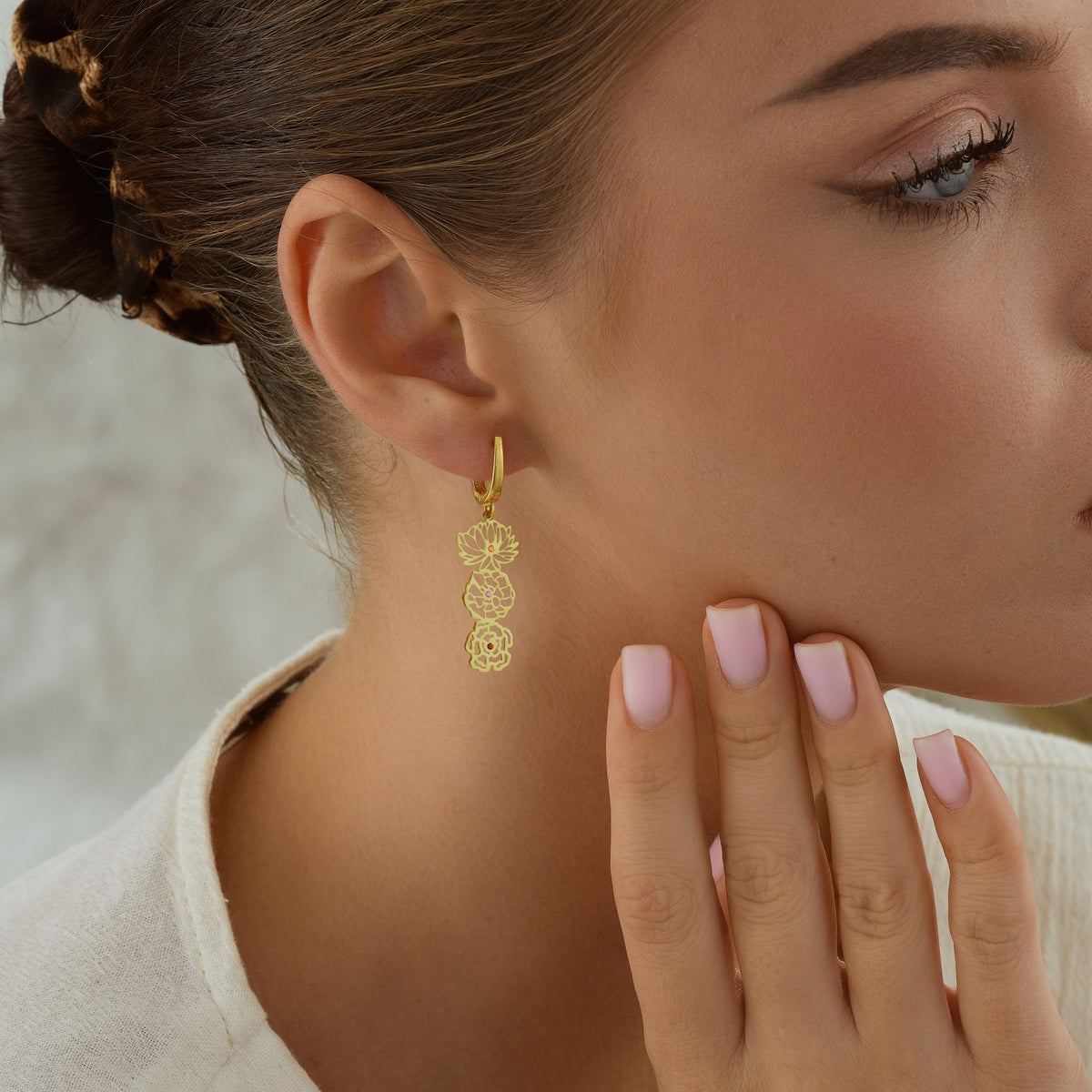 Birth flower drop earring on ear
