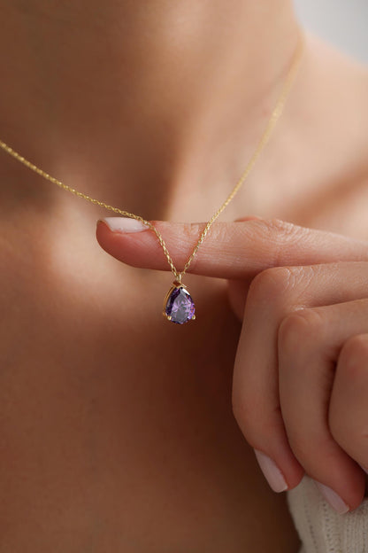 Amethyst teardrop necklace held in hand