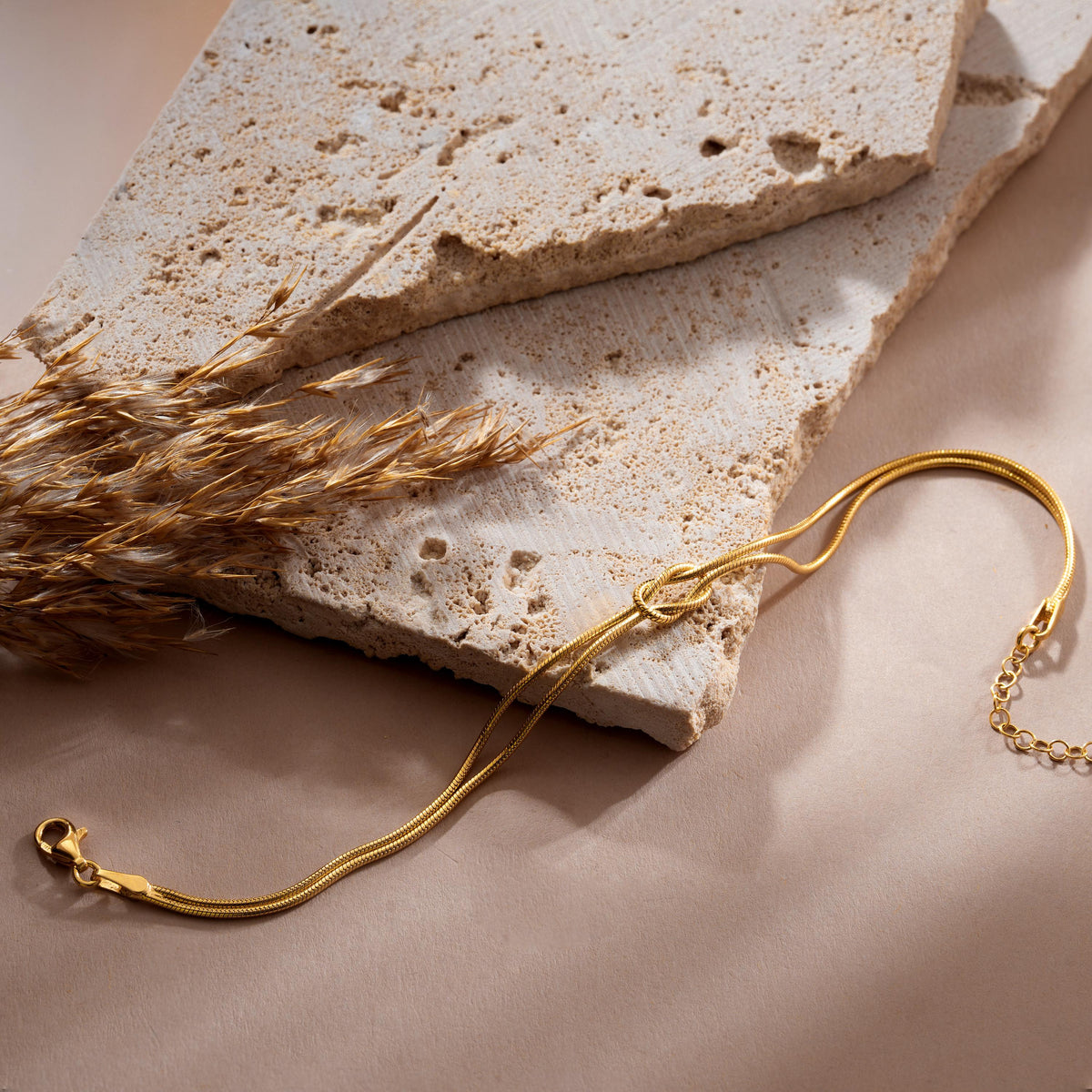 Knot bangle bracelet in gold plated finish