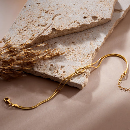 Knot bangle bracelet in gold plated finish