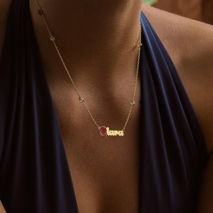 Enamel initial name necklace on a stone chain worn on the neck