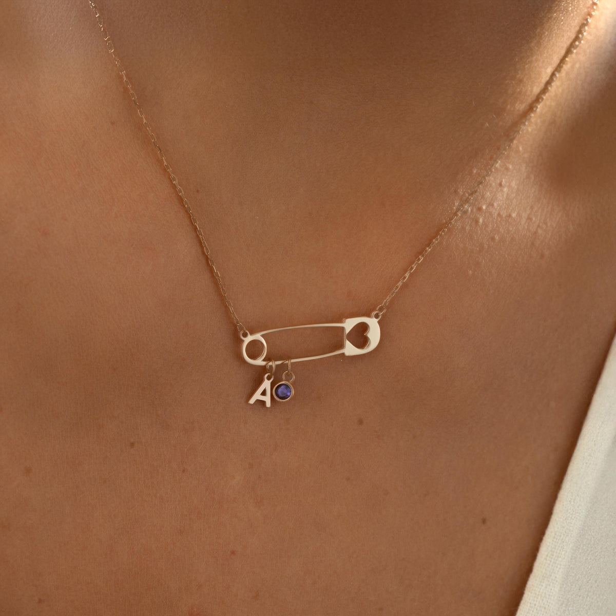 Safety pin necklace with birthstone detail