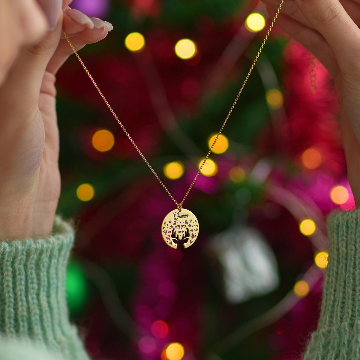 Reindeer medallion necklace styled as a Christmas gift