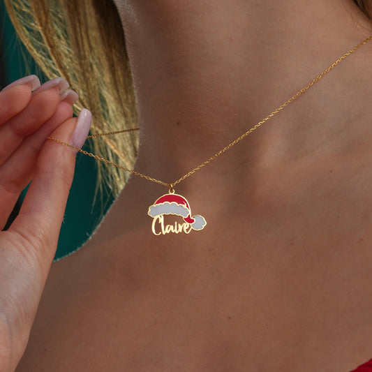 Santa hat name necklace worn by a woman