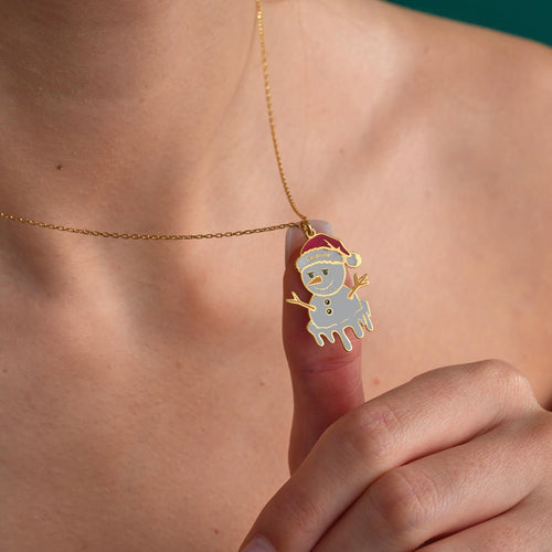 Personalized melting snowman name necklace held in hand