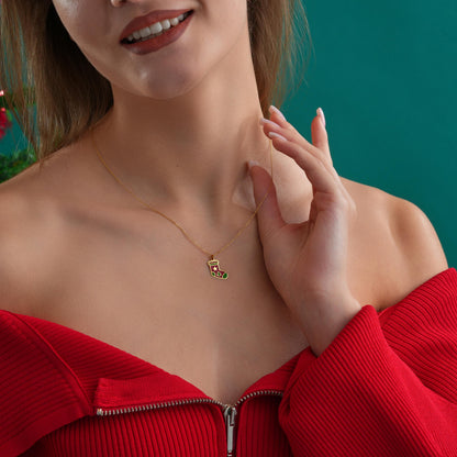Enamel stocking pendant shown against a festive background