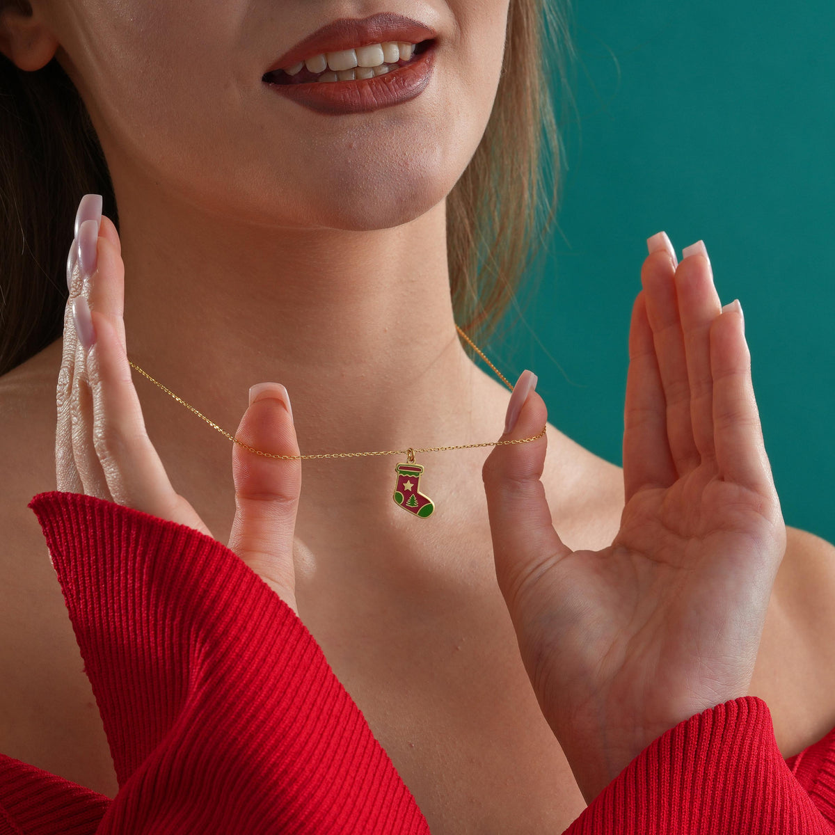 Red enamel Christmas stocking necklace worn by a woman
