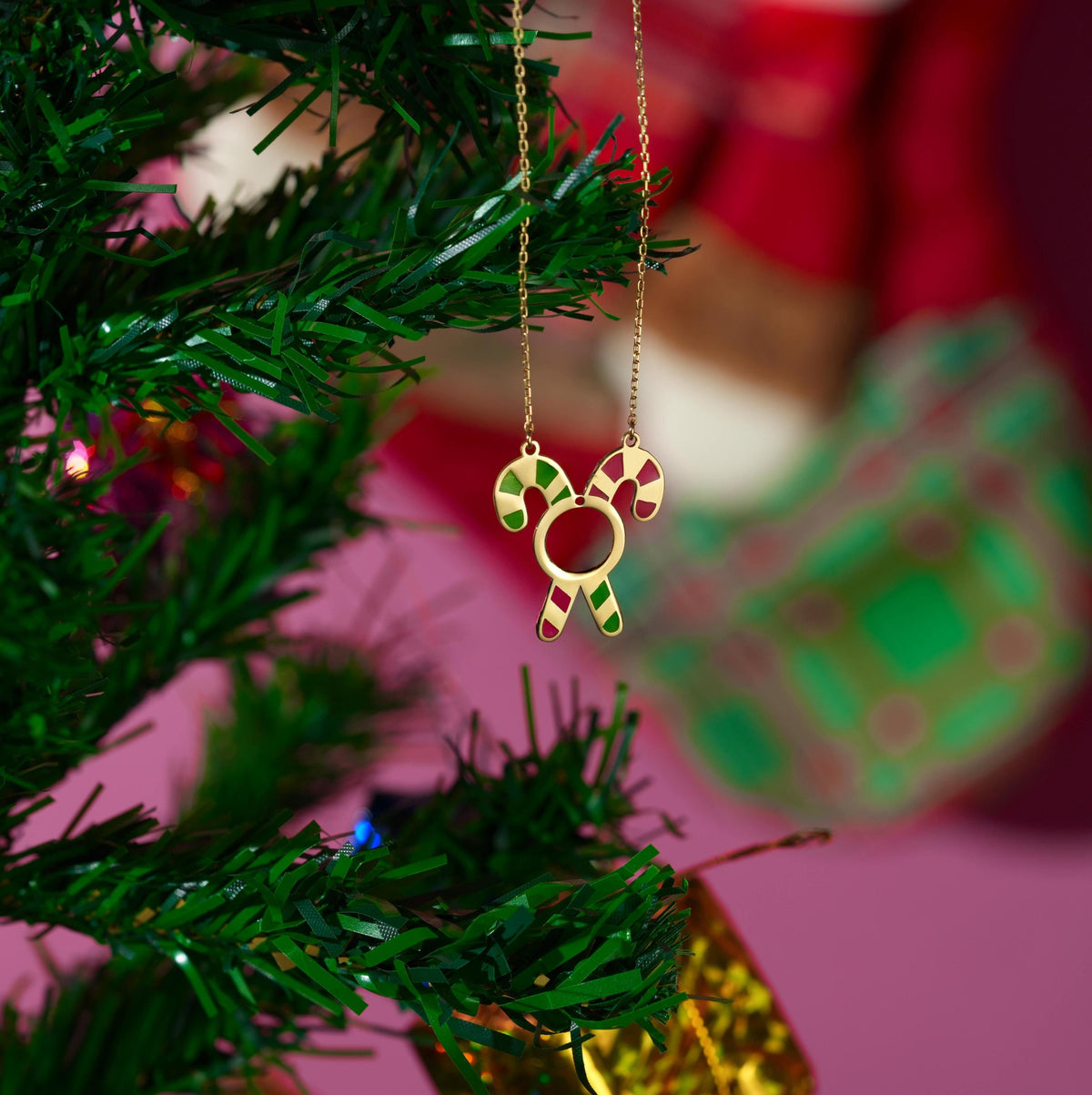 Candy cane Christmas necklace shown against a festive background
