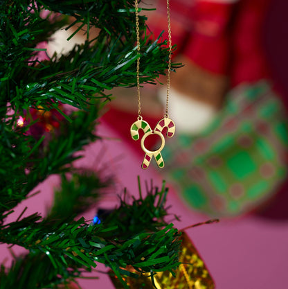 Candy cane Christmas necklace shown against a festive background