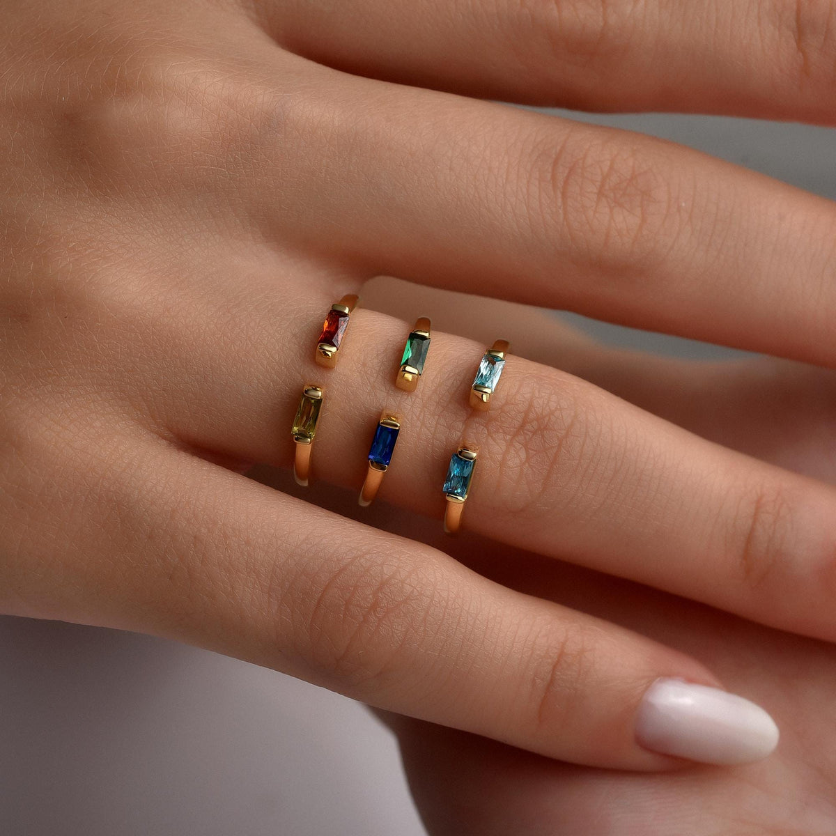 Duo baguette birthstone rings worn on the hand