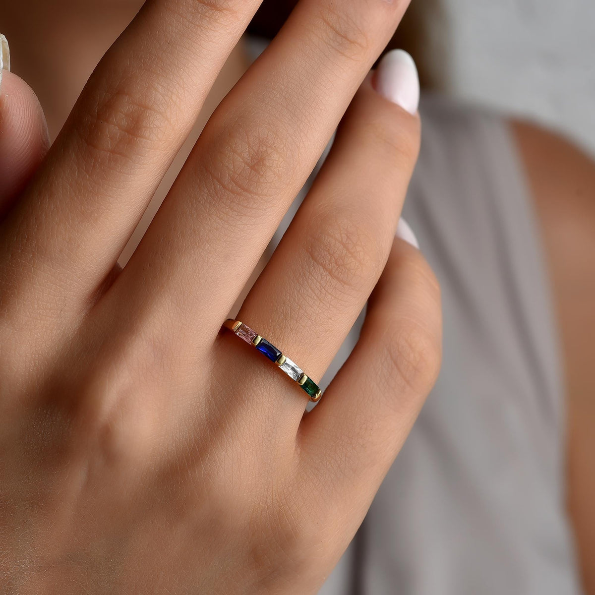 Family birthstone ring worn on the hand