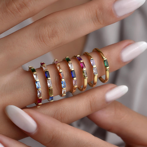 Baguette eternity birthstone rings worn stacked