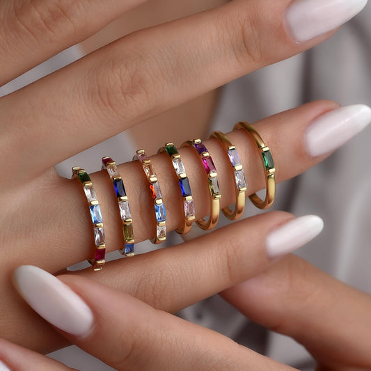 Baguette eternity birthstone rings worn stacked