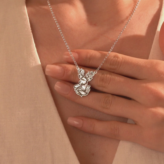 Silver majestic deer antler pendant necklace worn by a woman