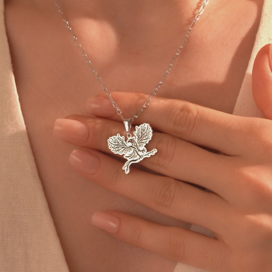 Detailed silver eagle pendant with botanical tree design