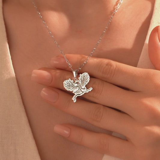 Detailed silver eagle pendant with botanical tree design