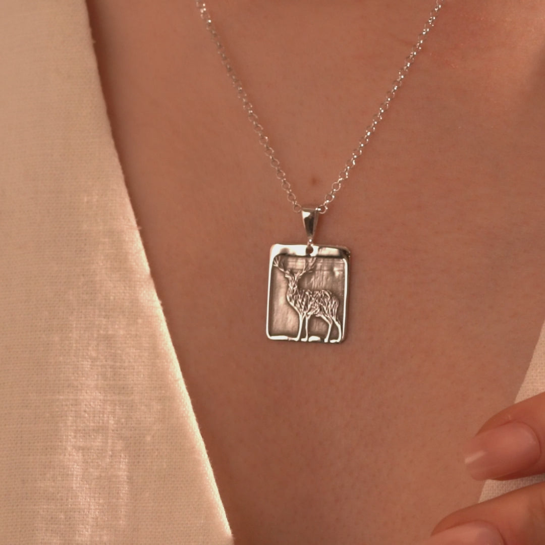 Silver deer necklace with rectangular open frame