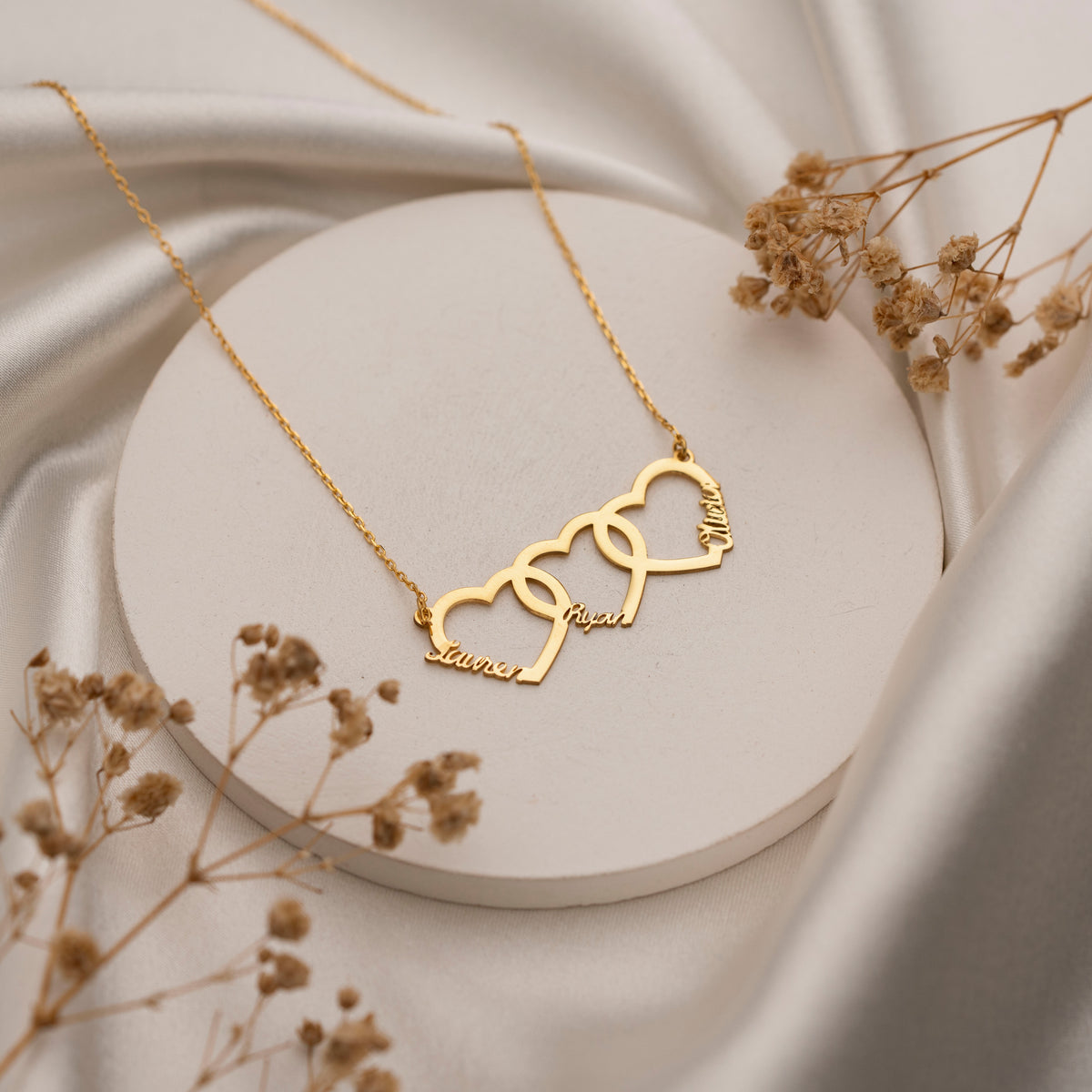 Three connected heart necklace personalized with family names